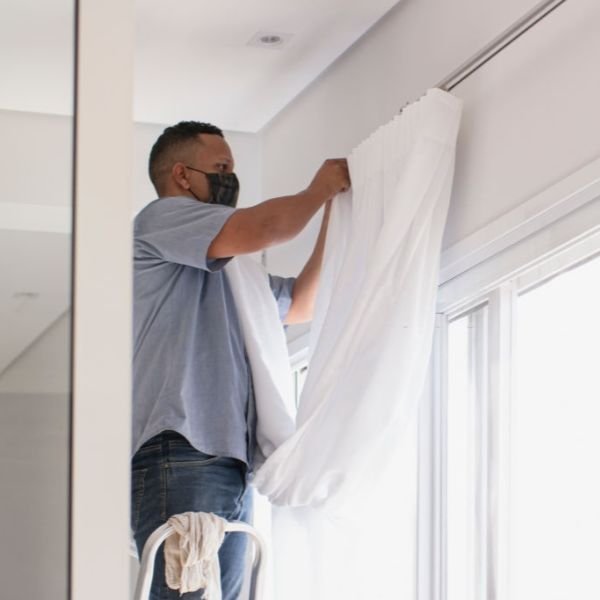 DubaiCurtains Man installing curtains in Room
