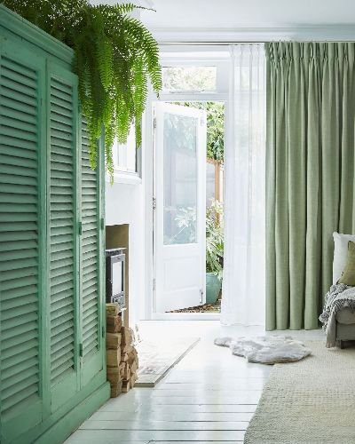 Sunlit space with green wardrobe