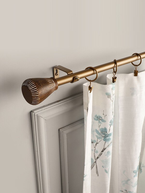 Brass curtain rod with finial