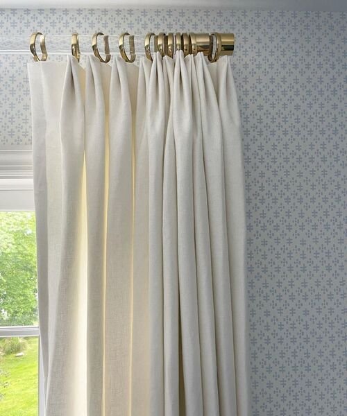 Cream curtains on gold rod