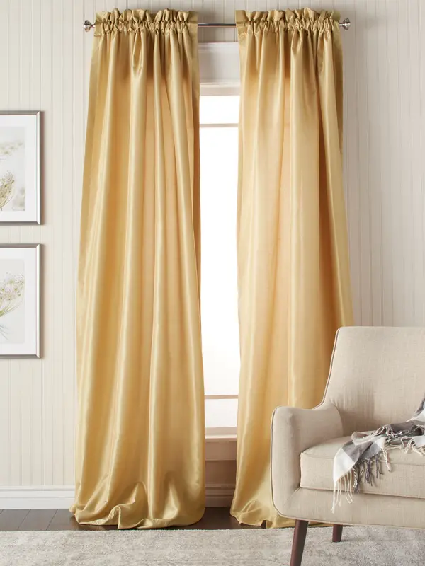 Gold curtains framing bright window